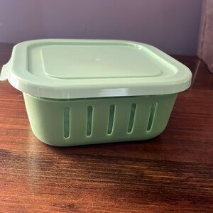 Reusable glass container with plastic lid and rubber holder
